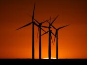 Wind turbines are silhouetted against the setting sun at the Spearville Wind Farm, Sunday, Sept. 29, 2024, near Spearville, Kan.