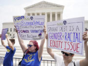 FILE - People demonstrate outside the Supreme Court, June 30, 2023, in Washington.