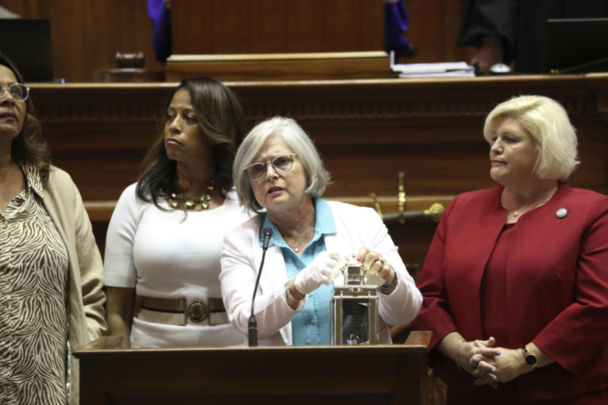 FILE - Four of South Carolina&rsquo;s Sister Senators, from left to right, Sen. Margie Bright Matthews, D-Walterboro, Sen. Mia McLeod, I-Columbia, Sen. Katrina Shealy, R-Lexington, and Sen. Penry Gustafson, R-Camden, stand in front of the Senate with their John F. Kennedy Profile in Courage award, June 26, 2024, in Columbia, S.C.