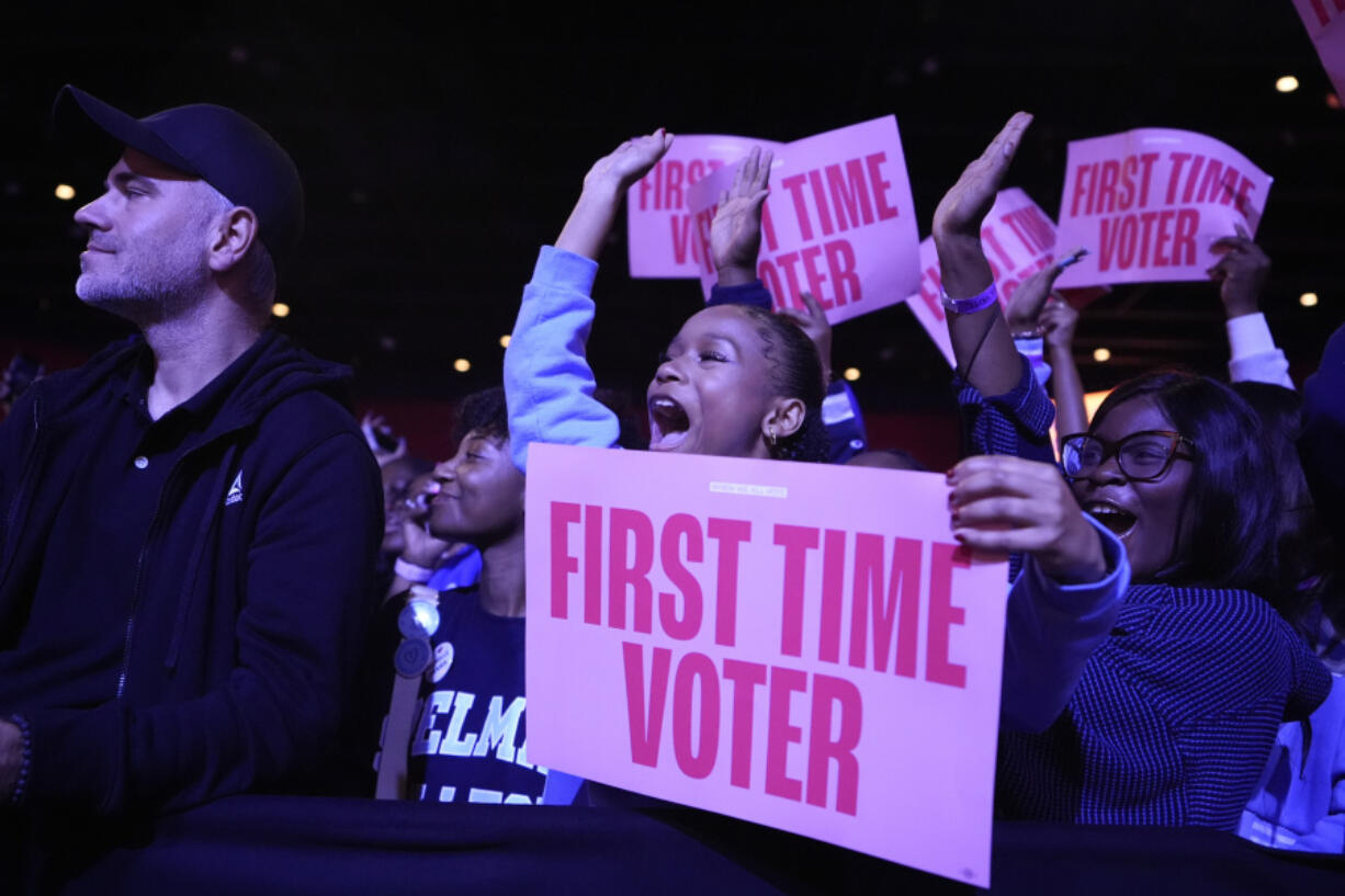 A first-time voter cheers before former first lady Michelle Obama speaks at campaign rally in support of Democratic presidential nominee Vice President Kamala Harris, Tuesday, Oct. 29, 2024, in College Park, Ga.