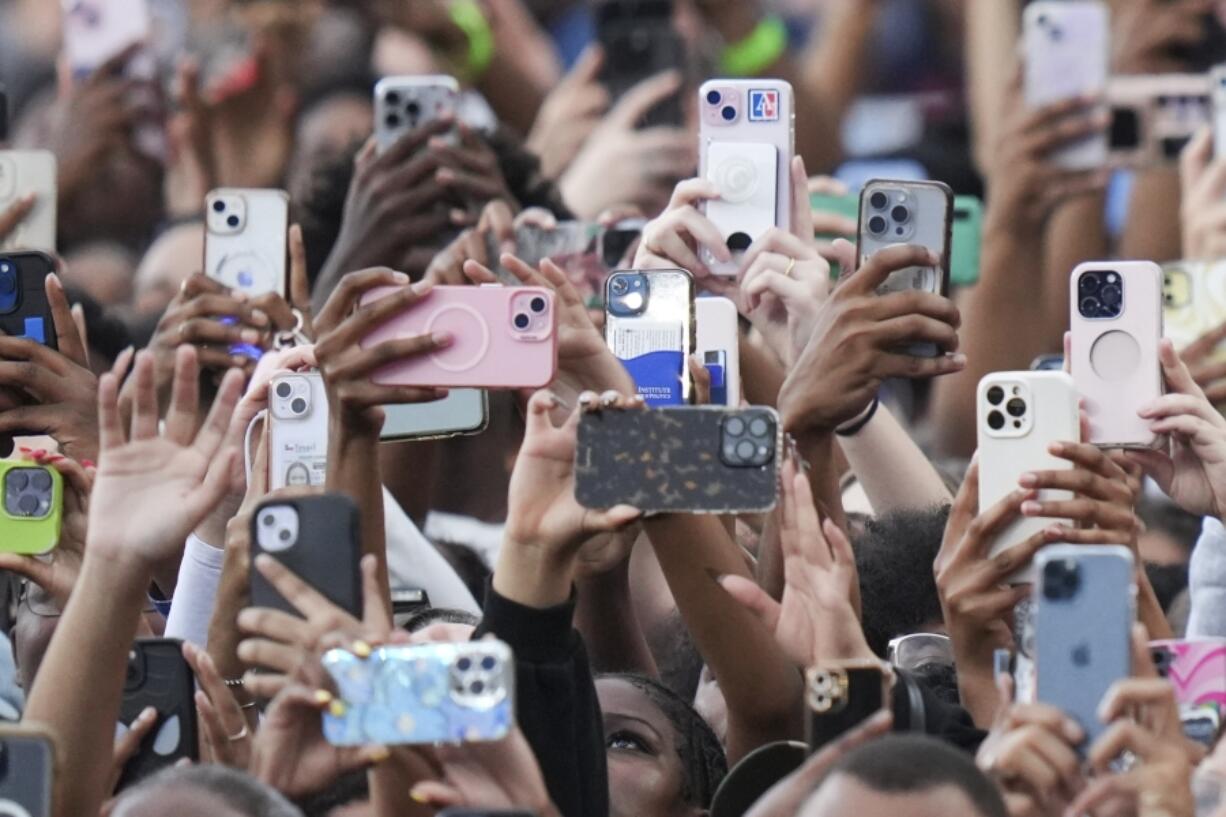 Supporters of Vice President Kamala Harris hold up their phones as she delivers a concession speech for the 2024 presidential election, Wednesday, Nov. 6, 2024, on the campus of Howard University in Washington.