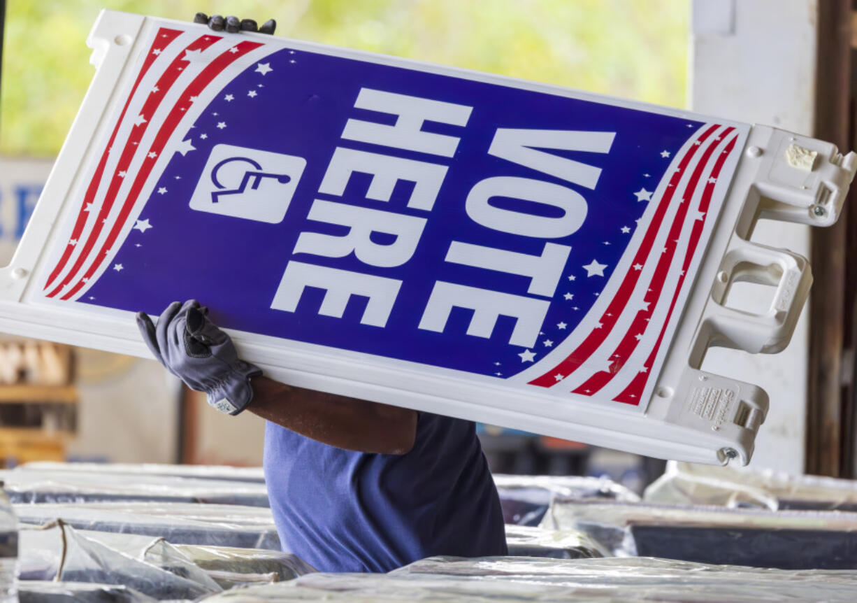 Voting machines and signs are loaded onto trucks from a warehouse in New Orleans East for delivery across the parish on Monday, Nov. 4, 2024, the day before the presidential election.