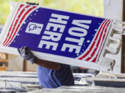 Voting machines and signs are loaded onto trucks from a warehouse in New Orleans East for delivery across the parish on Monday, Nov. 4, 2024, the day before the presidential election.