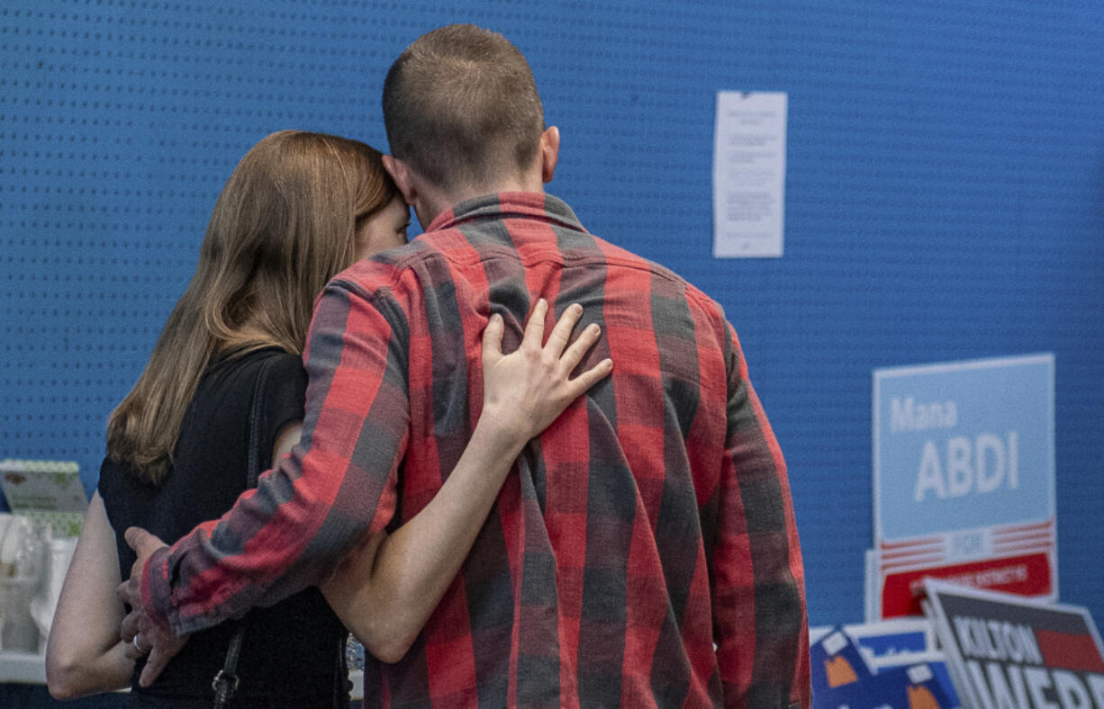 Rep. Jared Golden, D-Maine, embraces his wife Isobel Wednesday afternoon, Nov. 6, 2024, as he walks away from the podium after addressing the media during a press conference at his campaign office in Lewiston, Maine.