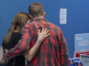 Rep. Jared Golden, D-Maine, embraces his wife Isobel Wednesday afternoon, Nov. 6, 2024, as he walks away from the podium after addressing the media during a press conference at his campaign office in Lewiston, Maine.