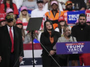 Carmen Ramirez, mother of Minelys &ldquo;Mimi&rdquo; Rodriguez Ramirez speaks as Republican presidential nominee former President Donald Trump, left, listens during a campaign rally at Atrium Health Amphitheater, Sunday, Nov. 3, 2024, in Macon, Ga.