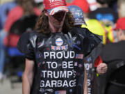 Supporters wearing garbage bags, arrive for a campaign rally for Republican presidential nominee former President Donald Trump, at First Horizon Coliseum, Saturday, Nov. 2, 2024, in Greensboro, NC.