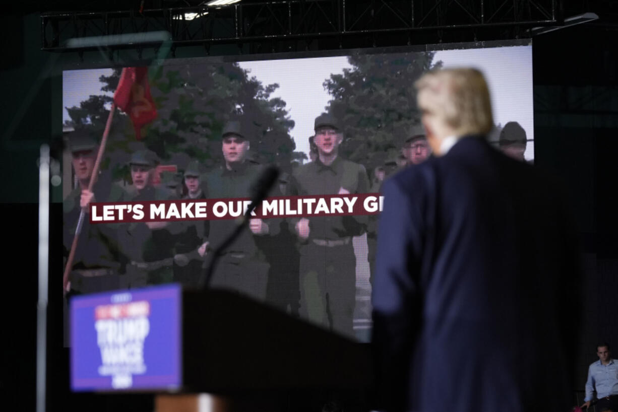 Republican presidential nominee former President Donald Trump watches as a video plays during a campaign rally at Greensboro Coliseum, Tuesday, Oct. 22, 2024, in Greensboro, N.C.