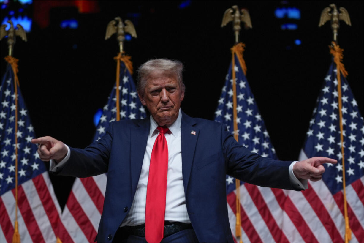 Republican presidential nominee former President Donald Trump gestures after a Tucker Carlson Live Tour show at Desert Diamond Arena, Thursday, Oct. 31, 2024, in Glendale, Ariz.