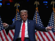 Republican presidential nominee former President Donald Trump gestures after a Tucker Carlson Live Tour show at Desert Diamond Arena, Thursday, Oct. 31, 2024, in Glendale, Ariz.