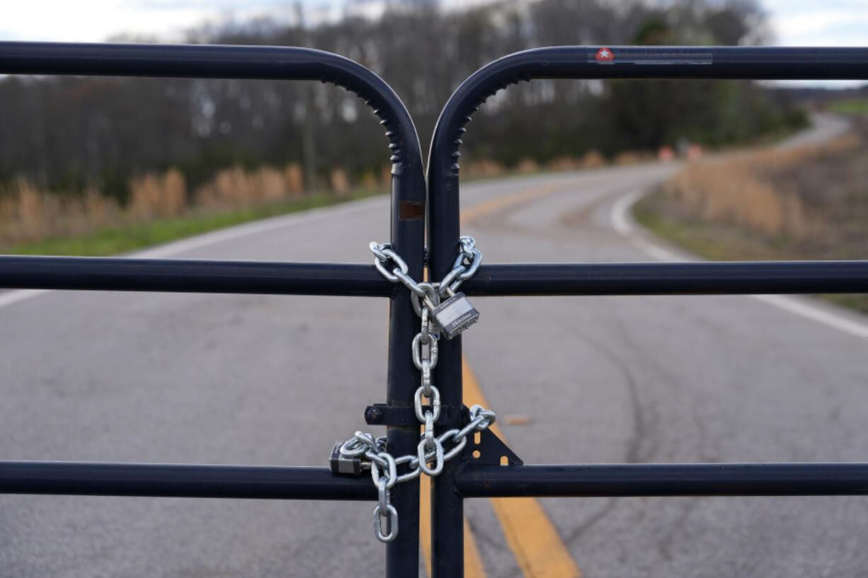 FILE - A locked gate on a closed road near the site of a planned Rivian electric truck plant is shown March 7, 2024, in Rutledge, Ga.