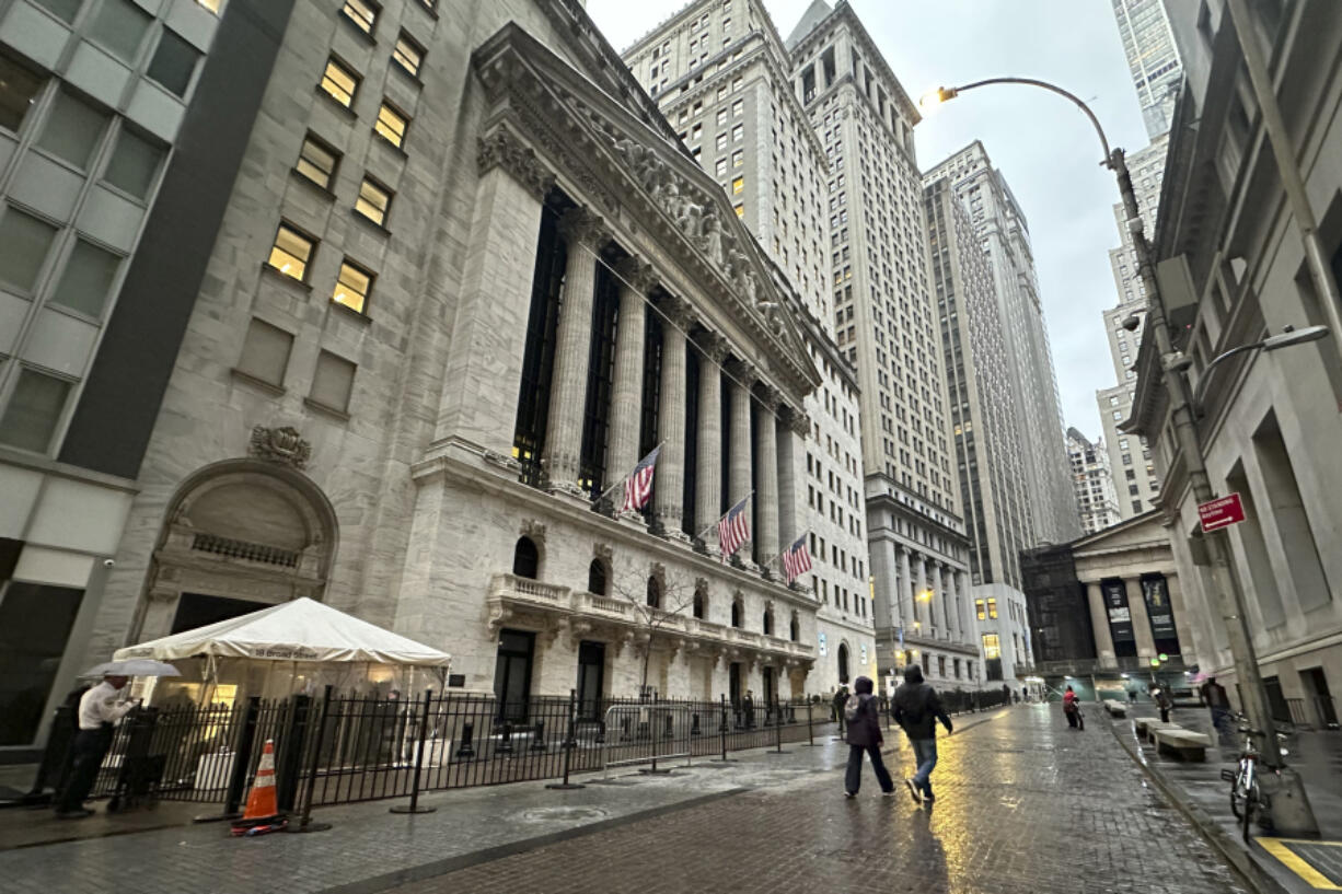 People walk past the New York Stock Exchange on Tuesday, Nov. 26 2024.