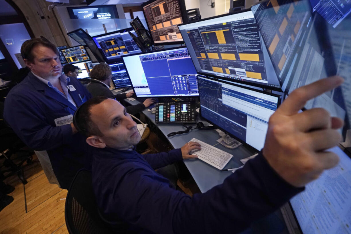 A pair of traders work in their booth on the floor of the New York Stock Exchange, Thursday, Nov. 7, 2024.