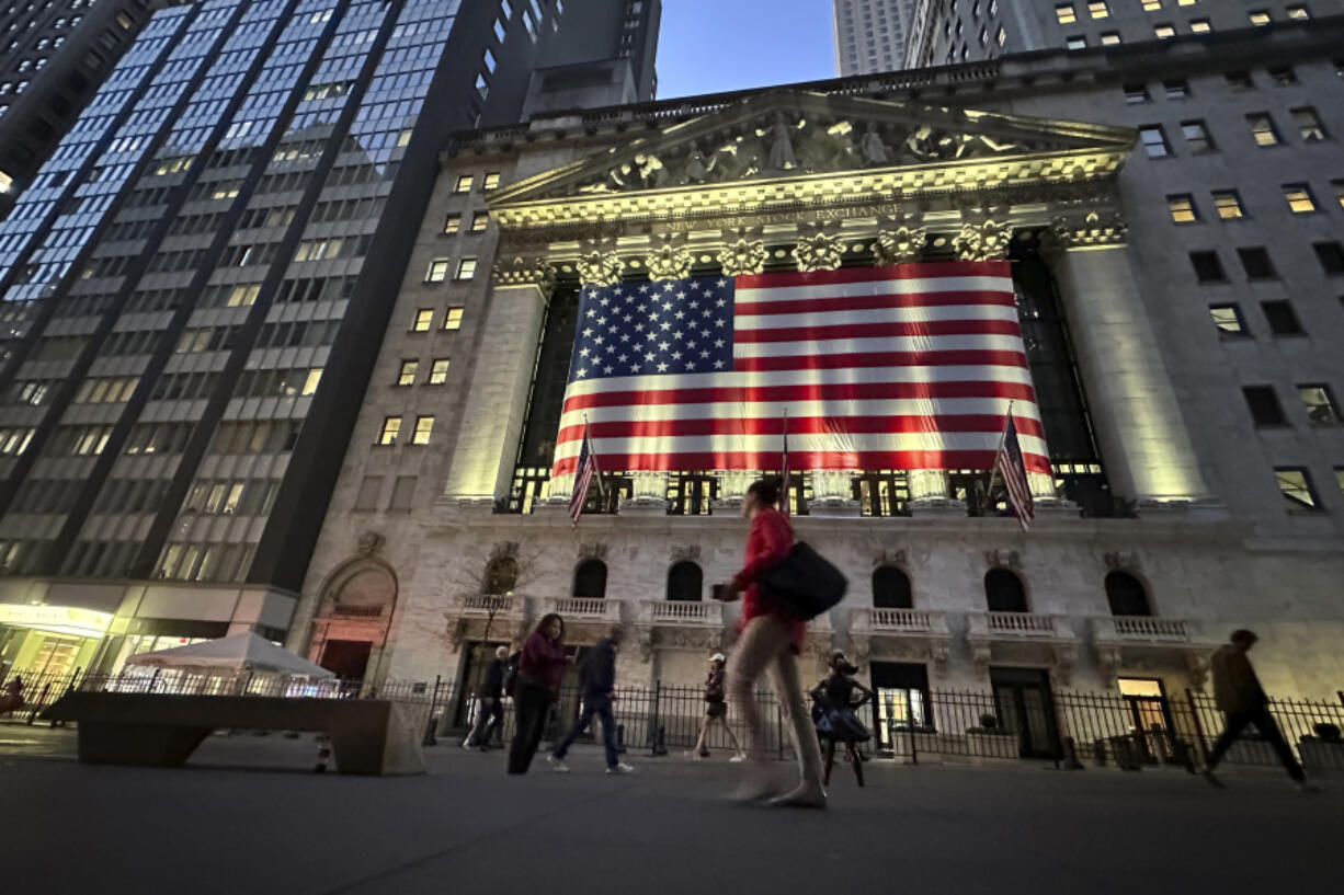 FILE - People pass the New York Stock Exchange on Nov. 5, 2024, in New York.