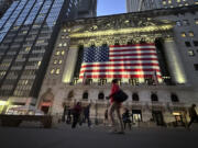 FILE - People pass the New York Stock Exchange on Nov. 5, 2024, in New York.