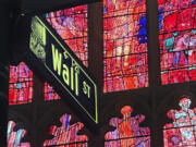 FILE - A sign marking Wall Street is shown near Trinity Church in New York&rsquo;s Financial District on Oct. 30, 2024.