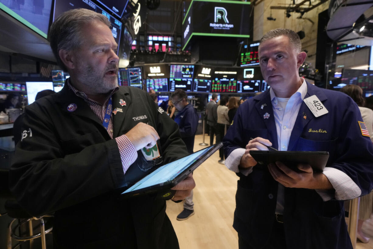 A pair of traders work on the floor of the New York Stock Exchange, Friday, Nov. 8, 2024.