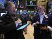 A pair of traders work on the floor of the New York Stock Exchange, Friday, Nov. 8, 2024.