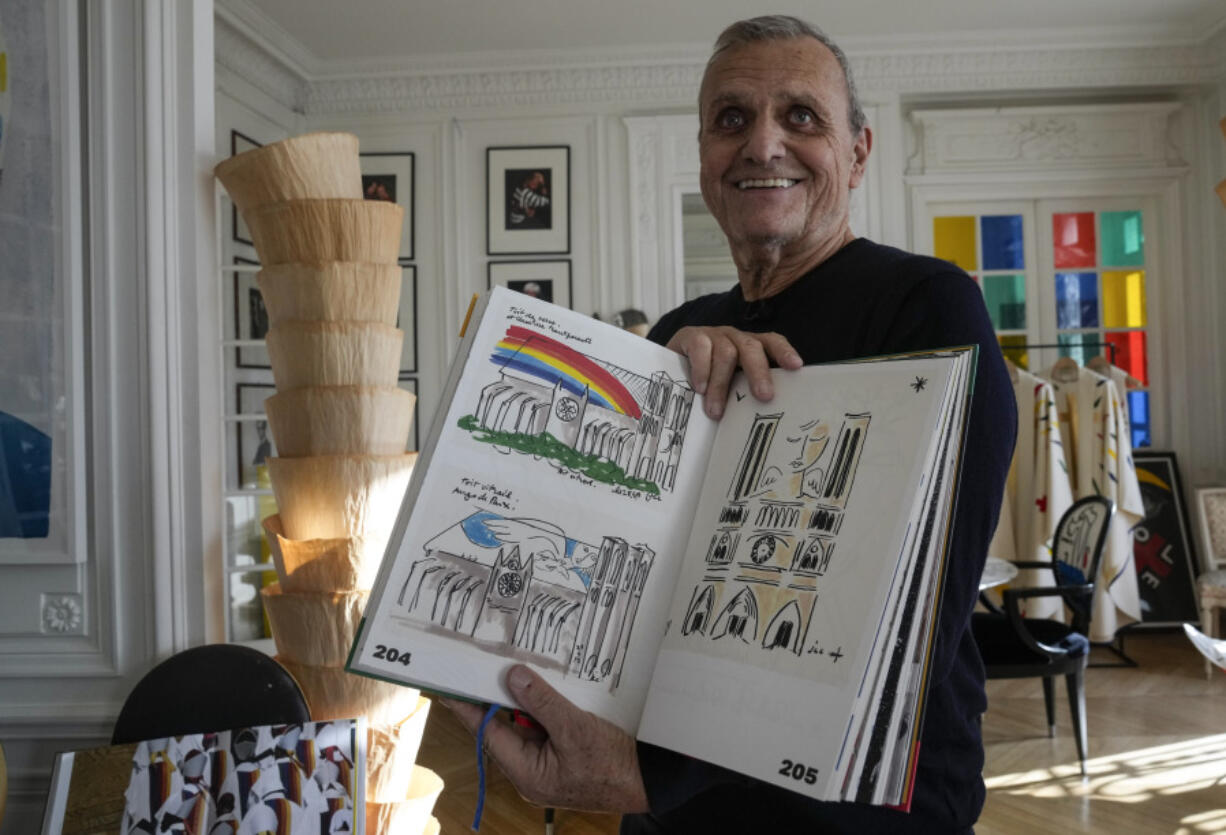 Designer Jean-Charles de Castelbajac displays his book with drawings Nov. 20 of the Notre Dame Cathedral in Paris.