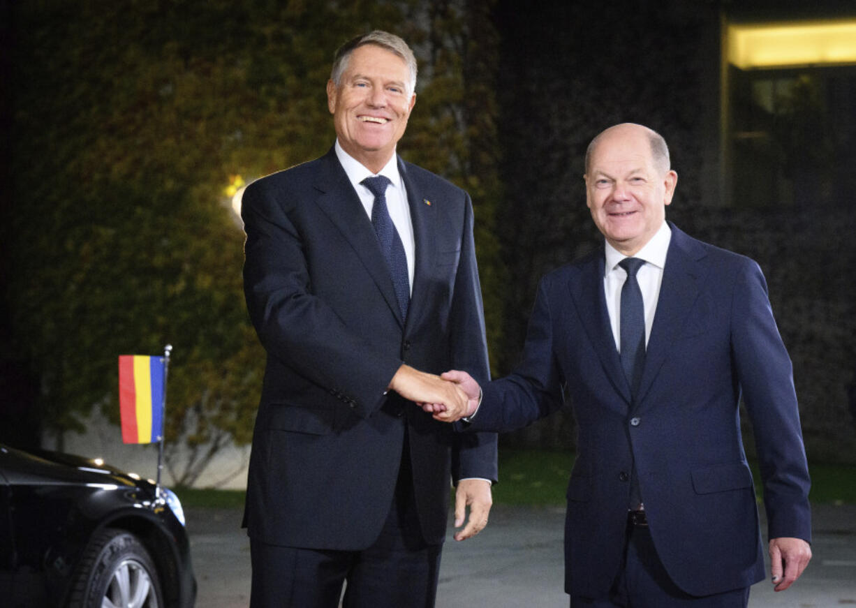 German Chancellor Olaf Scholz, right, welcomes Romanian President Klaus Iohannis, in Berlin Friday, Nov. 15, 2024.