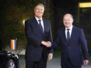 German Chancellor Olaf Scholz, right, welcomes Romanian President Klaus Iohannis, in Berlin Friday, Nov. 15, 2024.