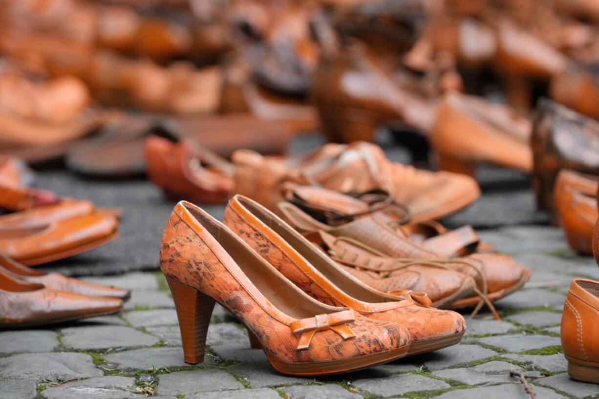 Women&rsquo;s rights activists set orange pair of shoes on the pavement for every attempted or successful killing of a woman by partner violence during the International Day for the Elimination of Violence Against Women, the start of the Orange Days in Cologne, Germany, Monday, Nov. 25, 2024.