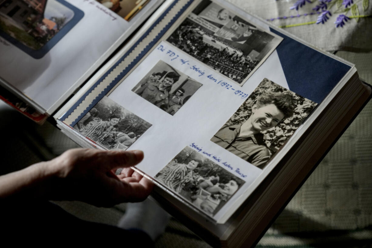 Solveig Leo, 81, former head of a large state-owned farm looks at her old photos album during her interview with the Associated Press in the northeastern village of Banzkow, Germany, Monday, Oct. 28, 2024.