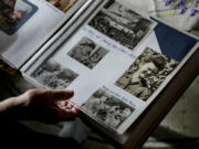 Solveig Leo, 81, former head of a large state-owned farm looks at her old photos album during her interview with the Associated Press in the northeastern village of Banzkow, Germany, Monday, Oct. 28, 2024.