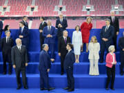 Hungary&rsquo;s Prime Minister Viktor Orban, center left front, speaks with French President Emmanuel Macron as other leaders pose during a group photo during the European Political Community (EPC) Summit at the Puskas Arena in Budapest, Thursday, Nov. 7, 2024.