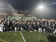 The Woodland football team poses for a photo after beating Ridgefield 14-7 to clinch its second consecutive 2A Greater St. Helens League championship on Friday, Nov. 1, 2024 at Woodland High School.