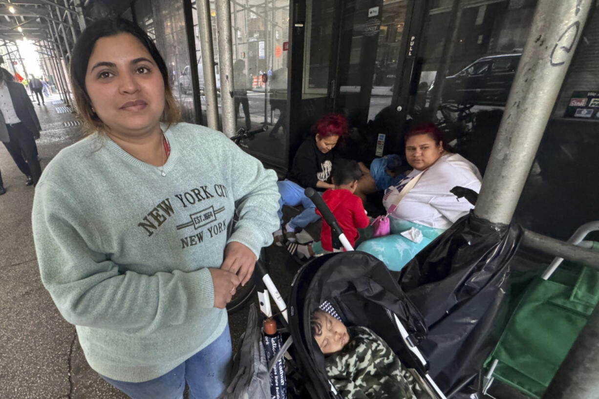 Maribel Hidalgo, 23, of Caracas, Venezuela, stands for a portrait with her son, Daniel, 2, outside a shelter for immigrants in New York, on Wednesday, Nov. 6, 2024.