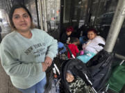 Maribel Hidalgo, 23, of Caracas, Venezuela, stands for a portrait with her son, Daniel, 2, outside a shelter for immigrants in New York, on Wednesday, Nov. 6, 2024.