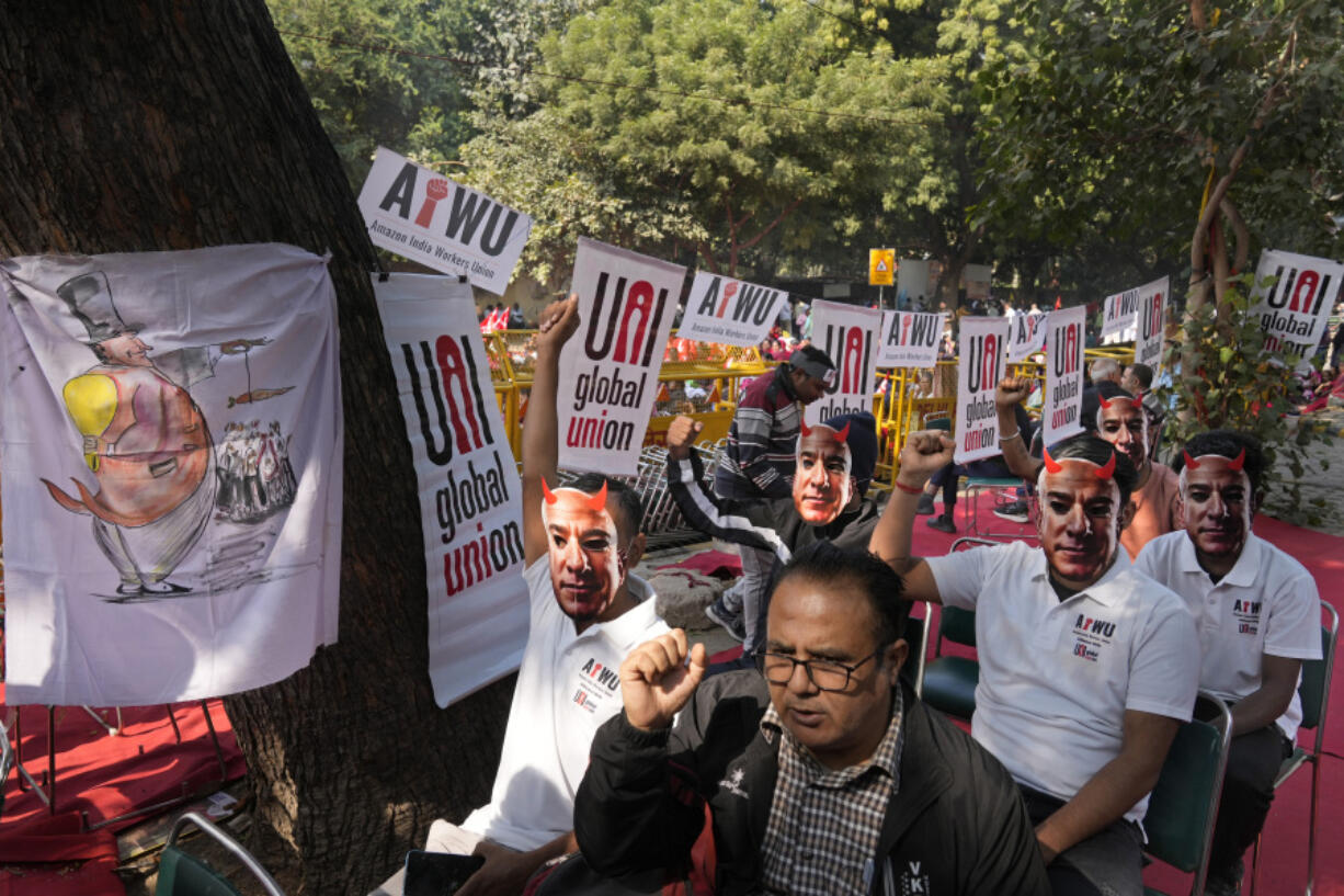 Participants wear paper masks in the likeness of Amazon&rsquo;s Jeff Bezos as warehouse workers and delivery drivers stage a protest against the Seattle-based company demanding higher wages and better working conditions, in New Delhi, India, Friday, Nov. 29, 2024.