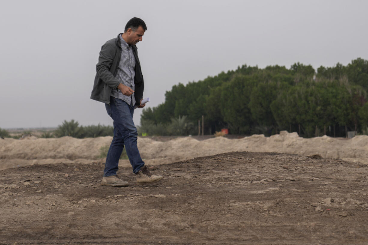 Dr Jaafar al Jotheri holds satellite images and explores the site of the Battle of al-Qadisiyah, which was fought in Mesopotamia - present-day Iraq - in the 630s AD between Arab Muslims and the army of the Sassanid Persian dynasty during a period of Muslim expansion. Abu Sakhir district- southern Najaf, Iraq, Sunday, Nov.10, 2024.