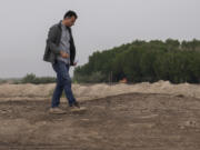 Dr Jaafar al Jotheri holds satellite images and explores the site of the Battle of al-Qadisiyah, which was fought in Mesopotamia - present-day Iraq - in the 630s AD between Arab Muslims and the army of the Sassanid Persian dynasty during a period of Muslim expansion. Abu Sakhir district- southern Najaf, Iraq, Sunday, Nov.10, 2024.