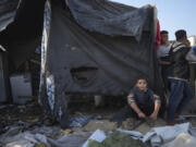 Palestinians gather at the site of an Israeli strike in the courtyard of the Al-Aqsa Hospital where displaced people live in tents, in Deir al-Balah, Gaza Strip, Saturday, Nov. 9, 2024.