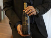 Israel Ganz, chairman of the Yesha settlers council and head of the Mateh Binyamin Regional Council, poses for a portrait holding a bottle of wine bearing the name of U.S. President-elect Donald Trump in the Shaar Binyamin Industrial Park in the West Bank, Monday, Nov. 11, 2024.