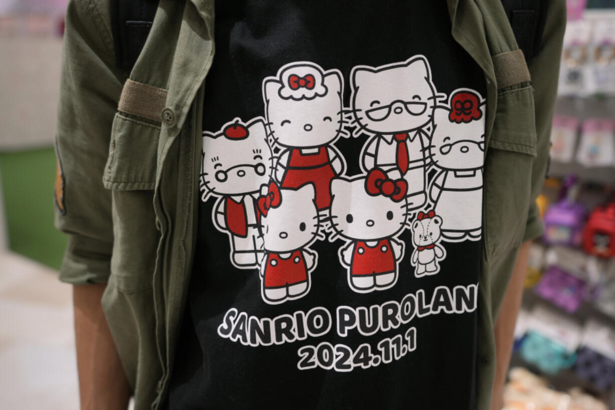 A Hello Kitty fan shows off his t-shirt showing Kitty&rsquo;s family members while visiting Sanrio Puroland to celebrate its best known character&rsquo;s 50th birth anniversary, in Tama, a western suburb of Tokyo, Japan, Friday, Nov. 1, 2024.