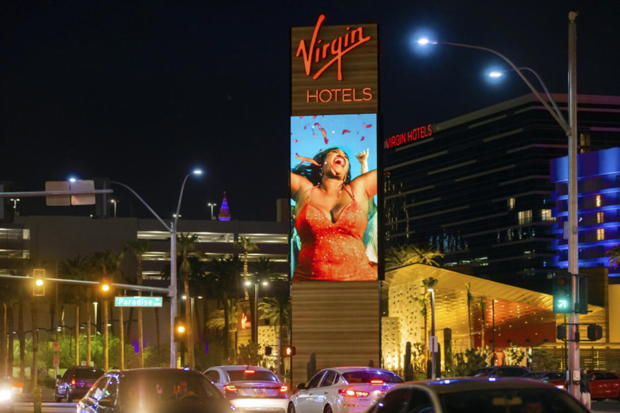 FILE - Virgin Hotels Las Vegas is illuminated on Wednesday, March 24, 2021, in Las Vegas.