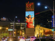 FILE - Virgin Hotels Las Vegas is illuminated on Wednesday, March 24, 2021, in Las Vegas.