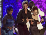 FILE - From left; Celia Cruz, Ricky Martin and Gloria Estefan perform during the opening number of the inaugural Latin Grammy Awards ceremony, in Los Angeles, Sept. 13, 2000.