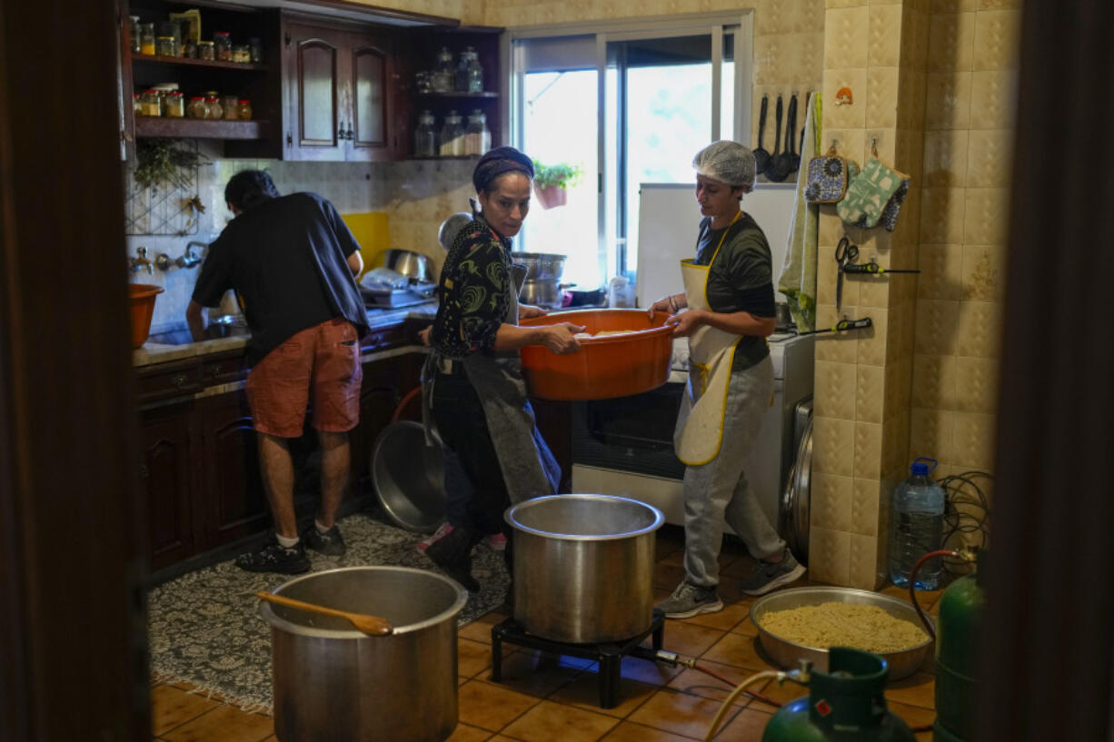 Volunteers prepare meals at a women&rsquo;s art center that was turned into a kitchen for displaced people who fled southern Lebanon amid the ongoing Hezbollah-Israel war, in the town of Aqaibe, northern Lebanon, Thursday, Oct. 24, 2024.