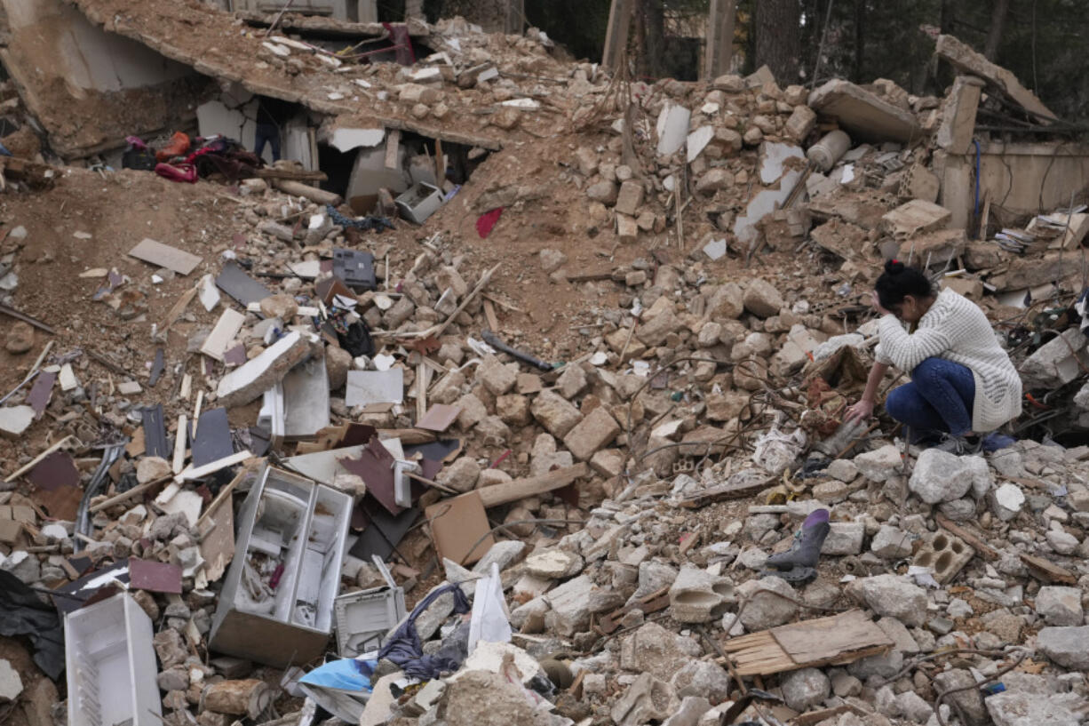 Lina Rida Jawhari, cries as she sits on the rubble of her family&rsquo;s destroyed house in Baalbek, eastern Lebanon, Thursday, Nov. 28, 2024.