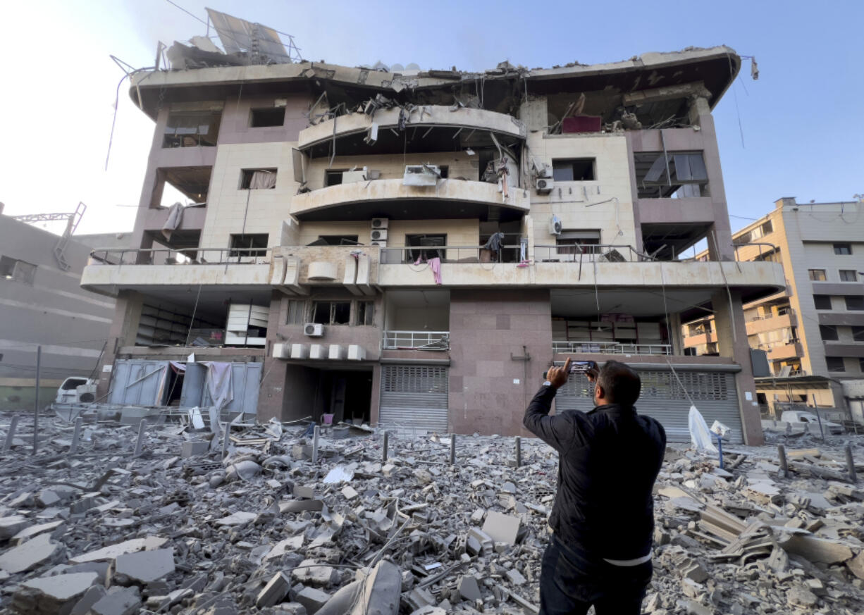 A man takes pictures by his mobile phone for his destroyed apartment attacked by an Israeli airstrike on Dahiyeh, in the southern suburb of Beirut, Lebanon, Friday, Nov. 1, 2024.