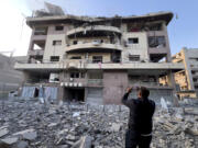 A man takes pictures by his mobile phone for his destroyed apartment attacked by an Israeli airstrike on Dahiyeh, in the southern suburb of Beirut, Lebanon, Friday, Nov. 1, 2024.