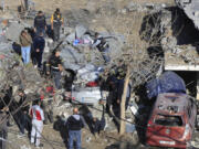 Lebanese Army Intelligence members inspect an army position that was damaged in an Israeli airstrike on Tuesday night, in Sarafand, southern Lebanon, Wednesday, Nov. 20, 2024.