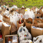 Bags of donated food and goods wait to be organized by Walk & Knock volunteers during the December 2022 food drive. (The Columbian Files)