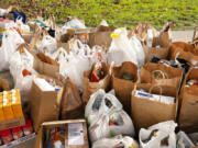 Bags of donated food and goods wait to be organized by Walk &amp; Knock volunteers during the December 2022 food drive.