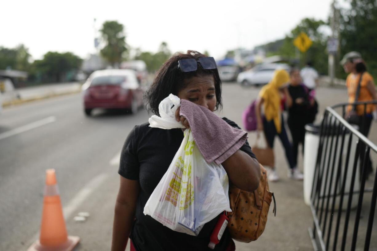 Hasly de Leon, from the Dominican Republic, cries after not being allowed by immigrations officials to board a bus transporting migrants north at a Mexican immigration checkpoint in Tapachula, Mexico, Sunday, Oct. 27, 2024.