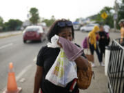 Hasly de Leon, from the Dominican Republic, cries after not being allowed by immigrations officials to board a bus transporting migrants north at a Mexican immigration checkpoint in Tapachula, Mexico, Sunday, Oct. 27, 2024.